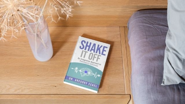 Shake it off Book By Dr. Greg Eckel sitting on a nightstand